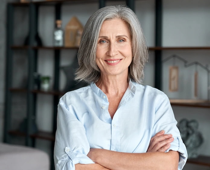 Portrait of senior woman smiling with arms crossed