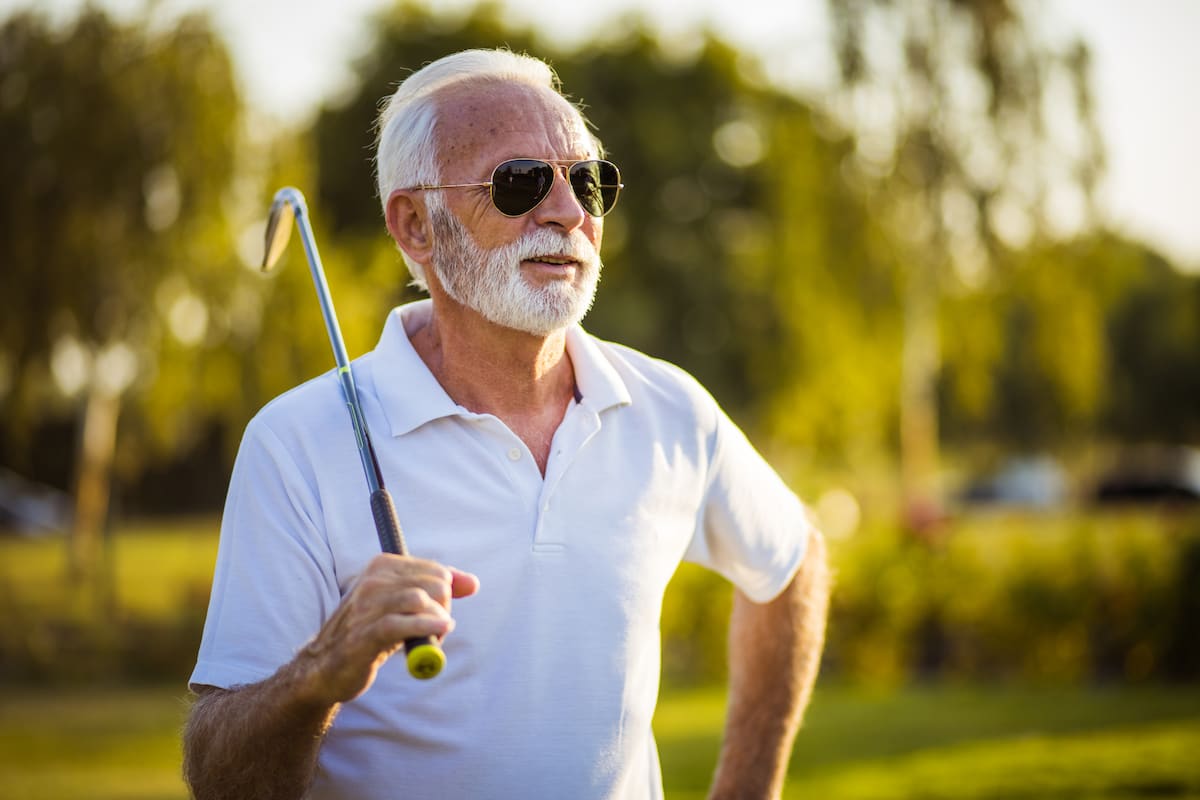 Senior man holding a golf club